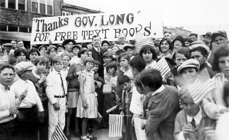 Louisiana schoolchildren thank Gov. Huey Long for free textbooks that increased enrollment by 20%.