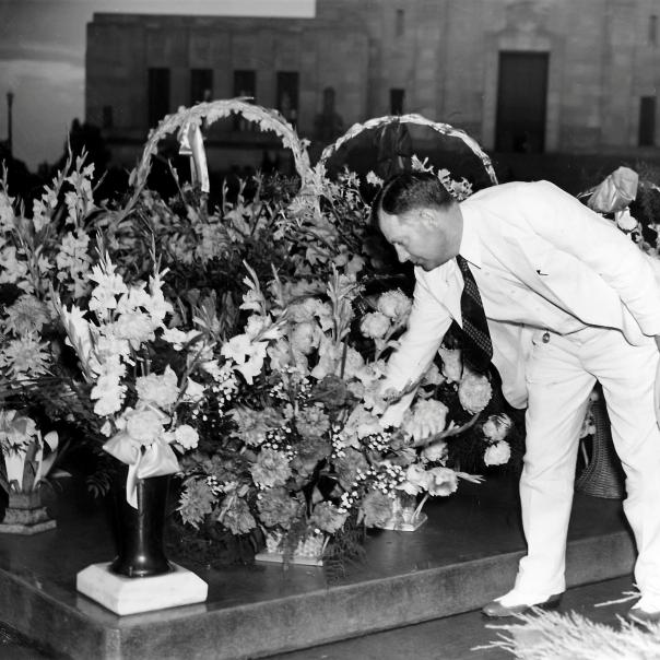 Huey's brother, Earl Long, lays flowers at Huey's gravesite on the Capitol grounds
