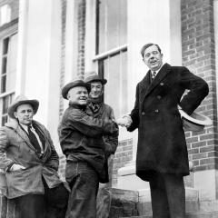 Huey Long shakes hands with constituents on the courthouse steps