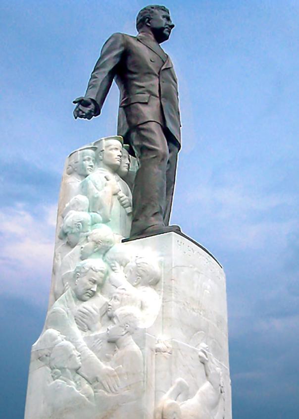 A bronze statue of Huey Long marks his grave on the grounds of the Louisiana State Capitol.