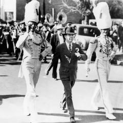 Huey Long marches with the Louisiana State University band. Long's first step to generate excitement for LSU was to quadruple the size of the marching band.